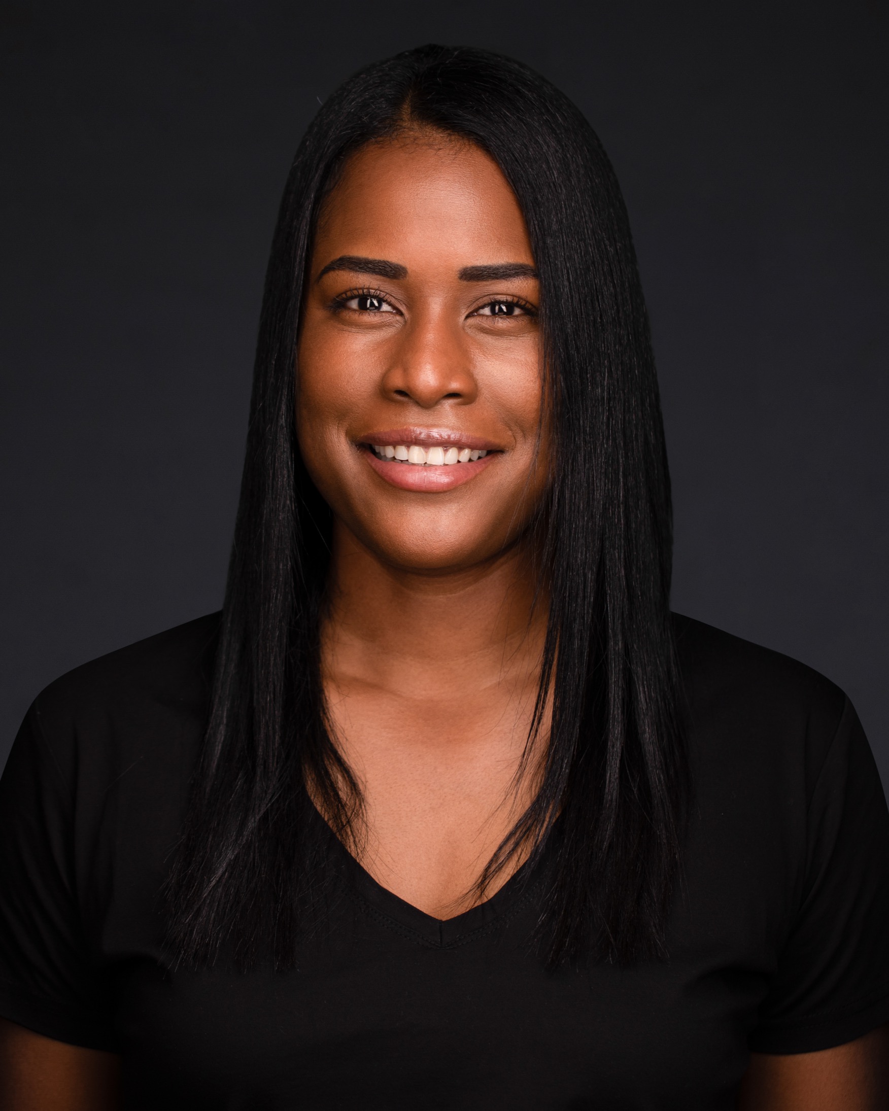 Yazuri Guido — smiling headshot in black